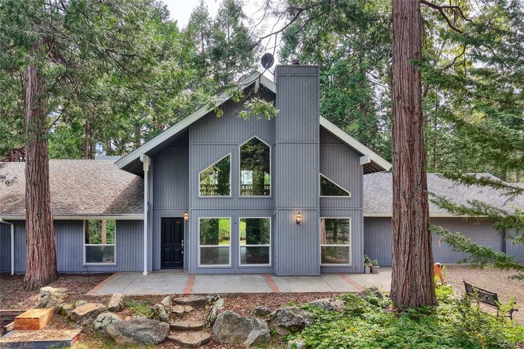 Gray A-frame home surrounded by tall pines at Hites Cove, Mariposa County